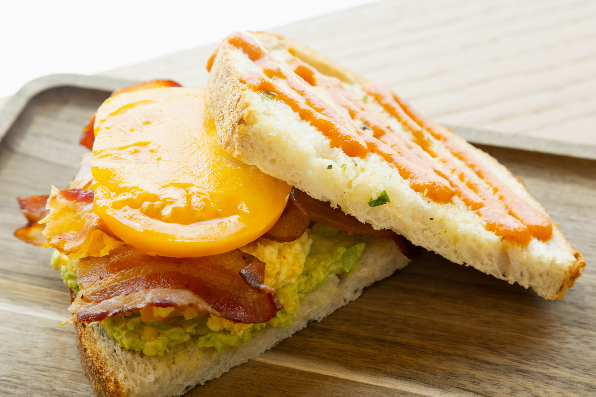 DUO breakfast sandwich with egg, bacon, avocado, and tomato