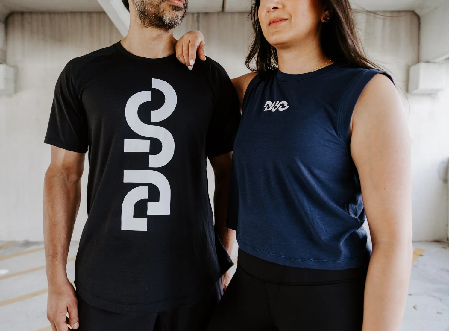 Two members of the DUO Houston community wearing DUO apparel